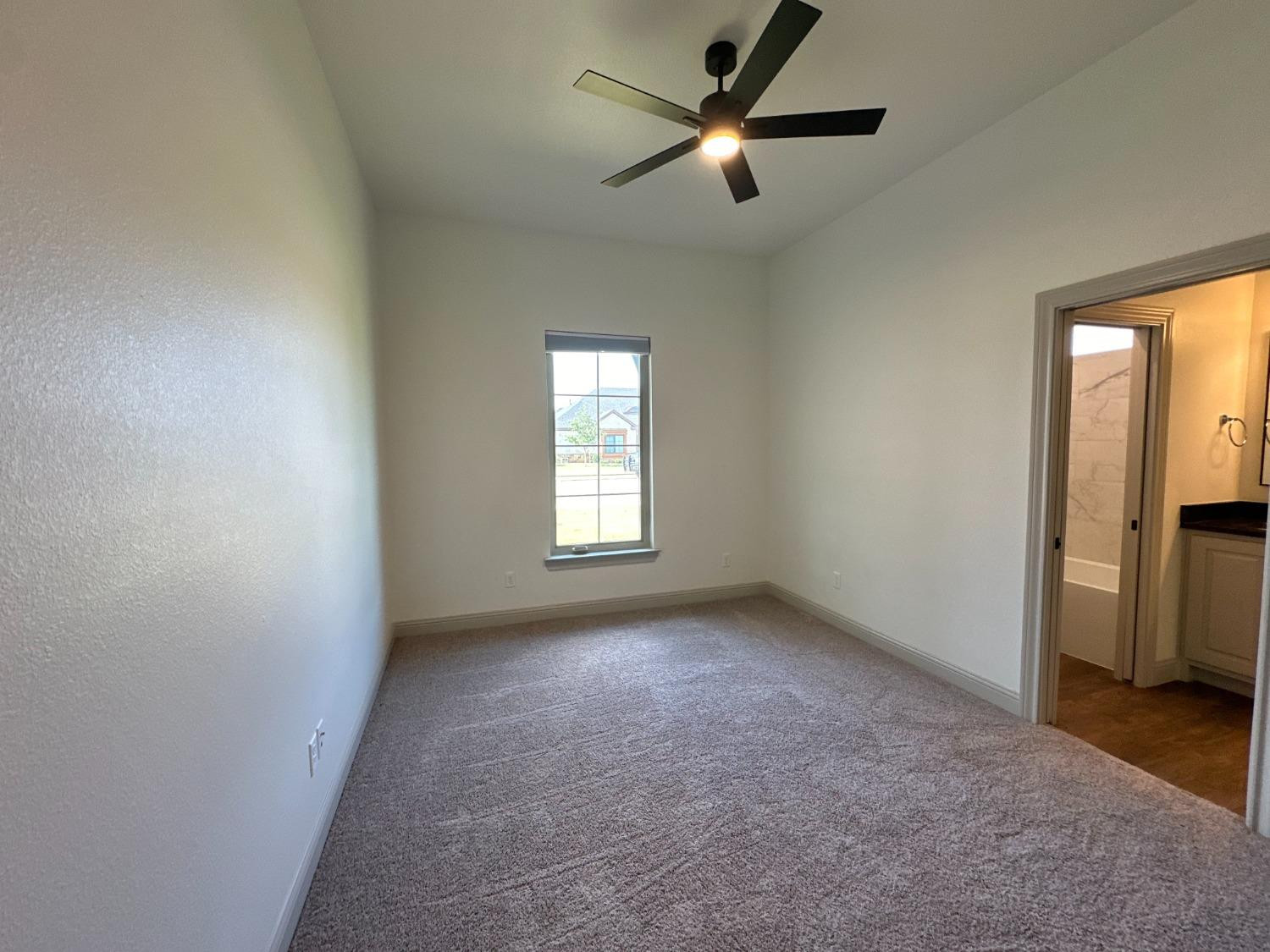 6959 103rd Street Lubbock, TX 79424 - Photo 32 of 49 an empty room with a window and a fan