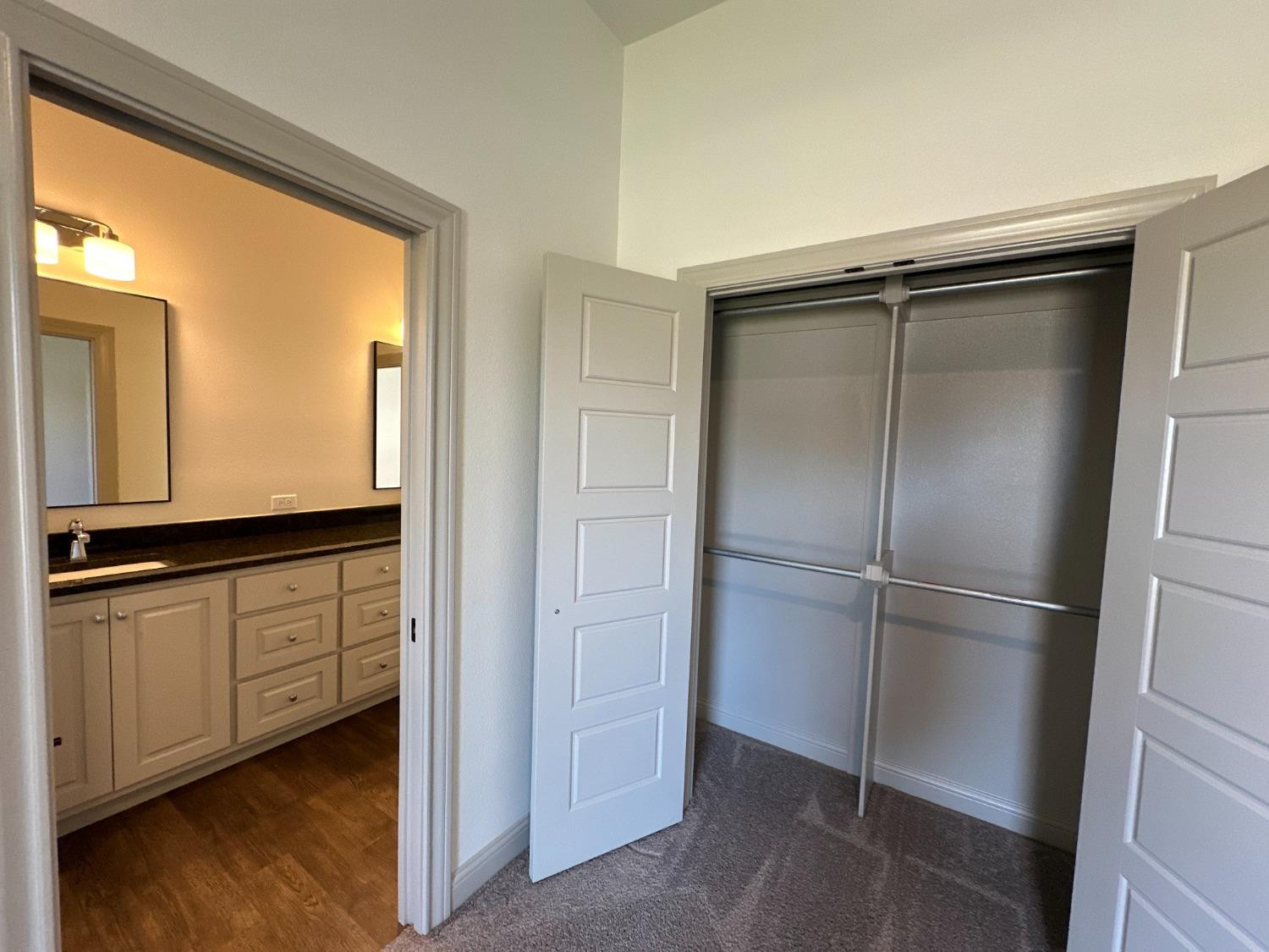 6959 103rd Street Lubbock, TX 79424 - Photo 35 of 49 a walk in closet with wooden floor