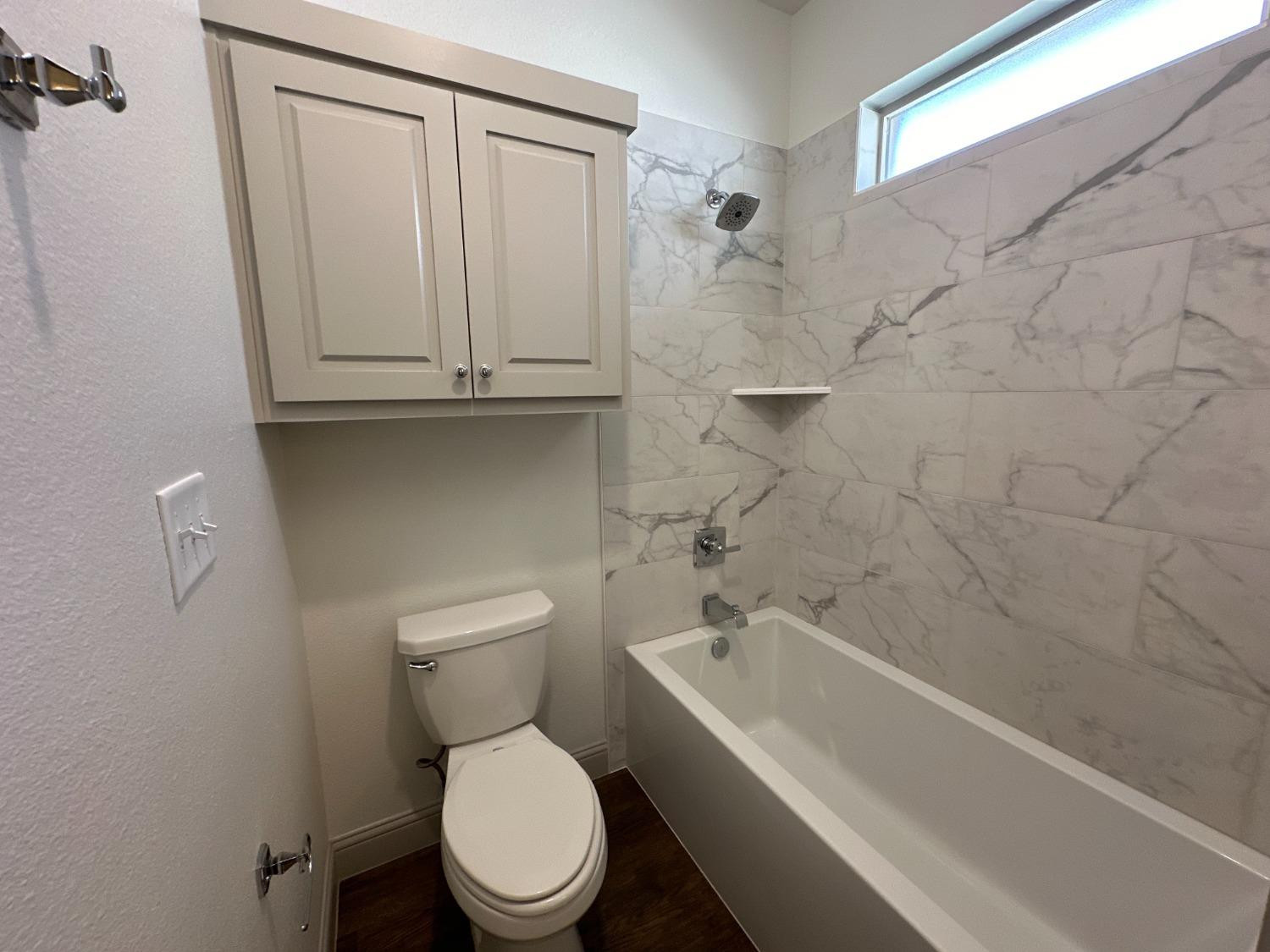 6959 103rd Street Lubbock, TX 79424 - Photo 36 of 49 a bathroom with a toilet and a bathtub