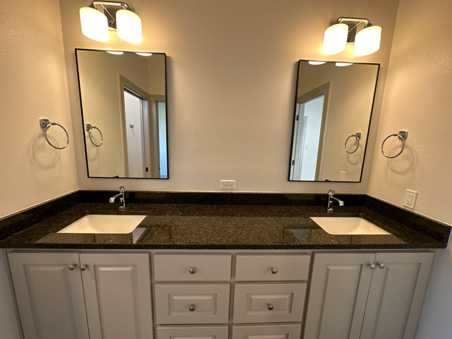 6959 103rd Street Lubbock, TX 79424 - Photo 37 of 49 a bathroom with sink and mirror