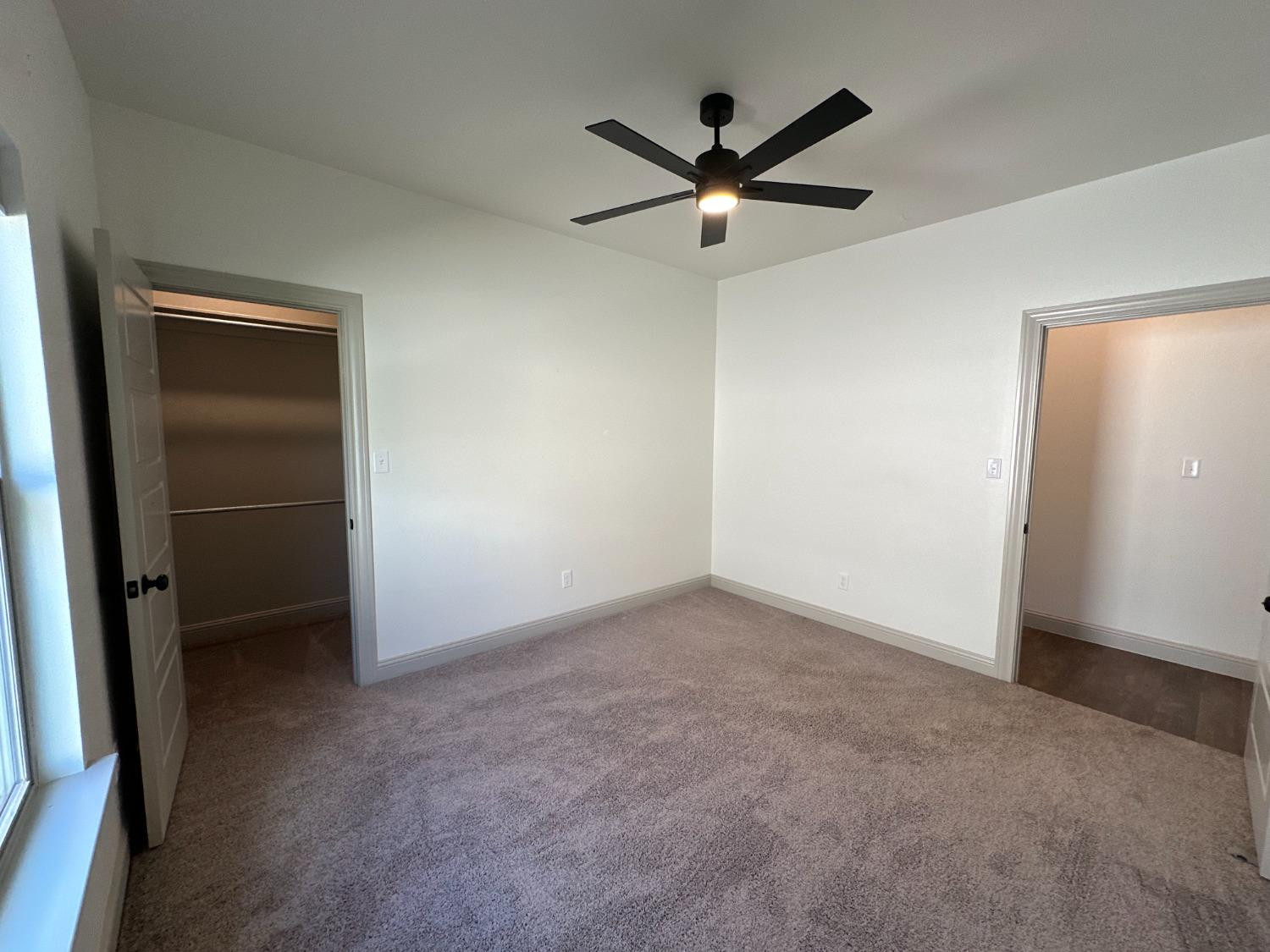 6959 103rd Street Lubbock, TX 79424 - Photo 40 of 49 an empty room with a ceiling fan and a window