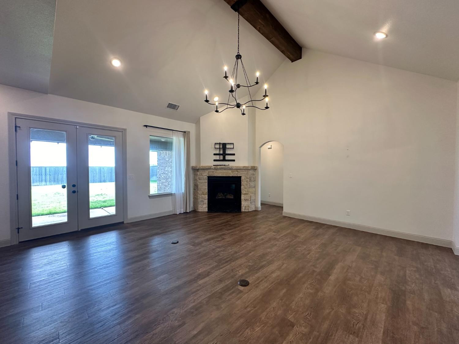 6959 103rd Street Lubbock, TX 79424 - Photo 4 of 49 a view of a room with chandelier fireplace and wooden floor