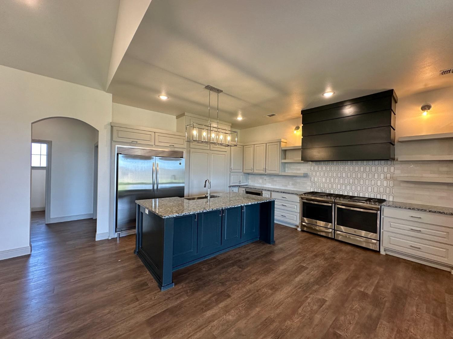 6959 103rd Street Lubbock, TX 79424 - Photo 5 of 49 a kitchen with stainless steel appliances granite countertop a stove a sink and a refrigerator