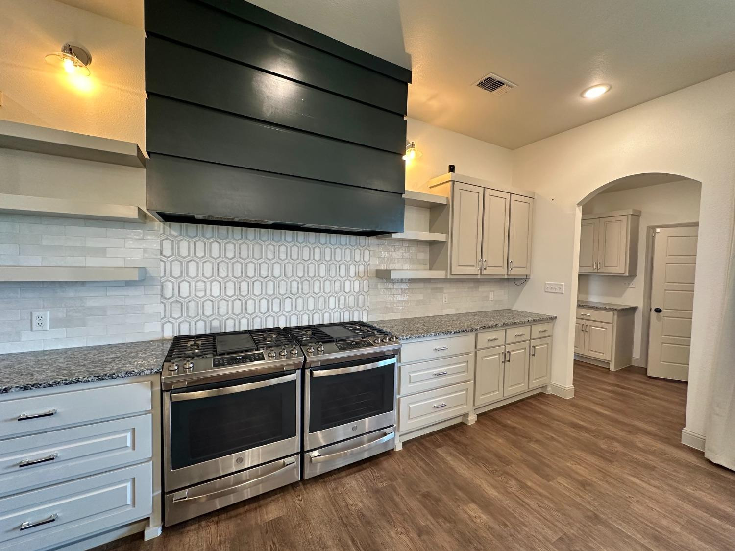 6959 103rd Street Lubbock, TX 79424 - Photo 6 of 49 a kitchen with stainless steel appliances granite countertop a stove a sink and a refrigerator