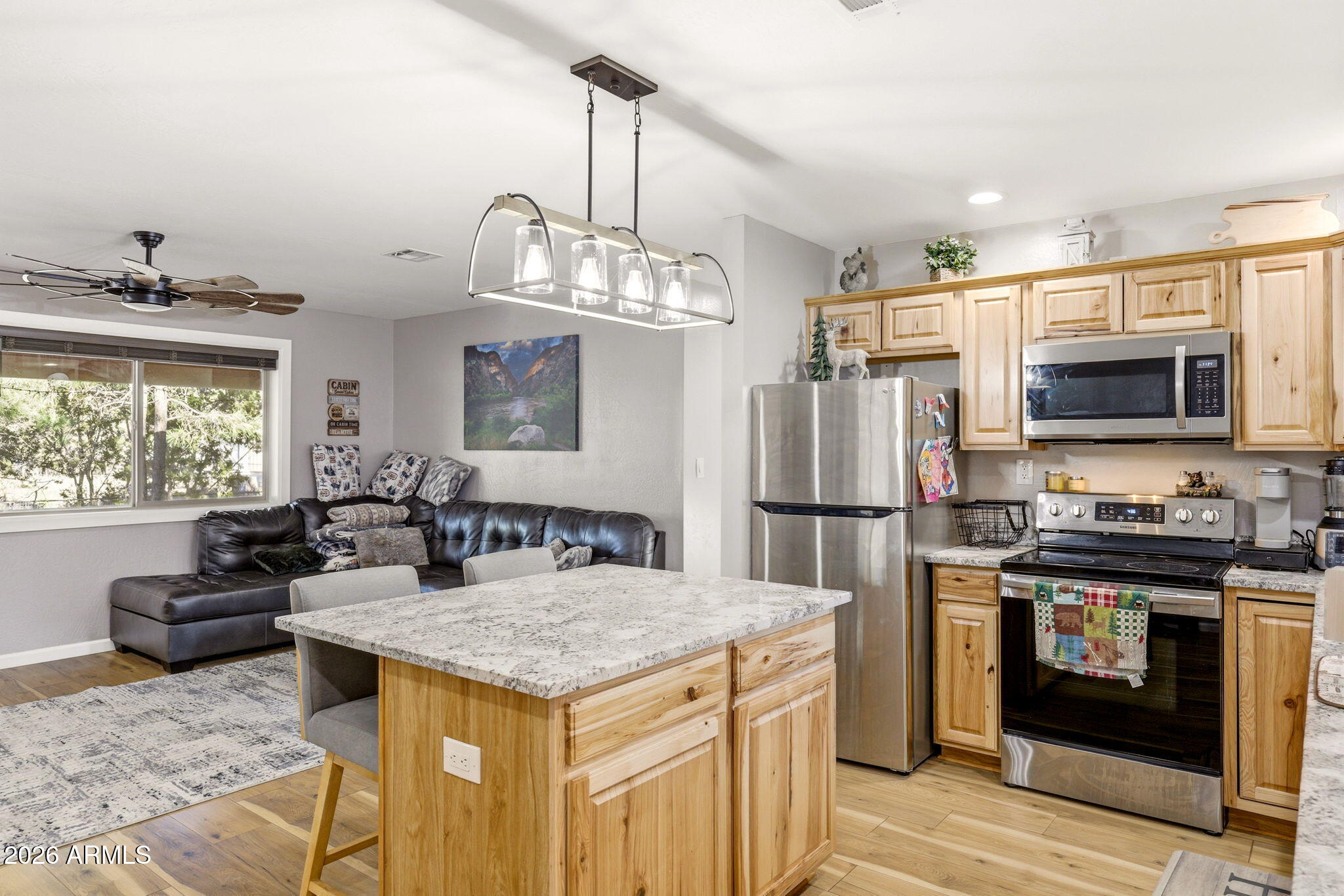 2900 Long Rifle Place Overgaard, AZ 85933 - Photo 10 of 35 a kitchen with kitchen island a counter space a sink appliances and cabinets