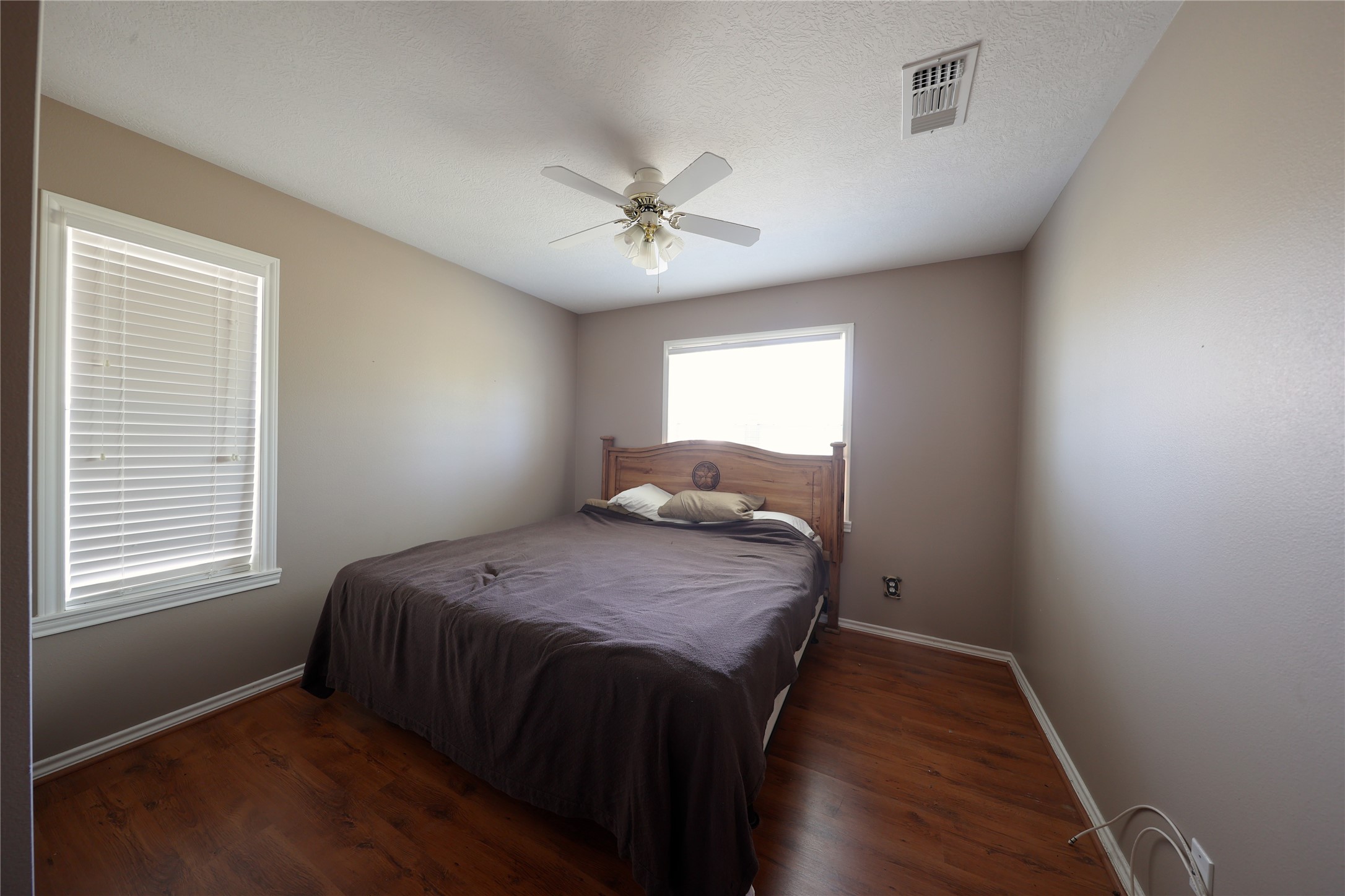 3337 Brunes Mill Road Columbus, TX 78934 - Photo 15 of 48 a bed sitting in a bedroom next to a window