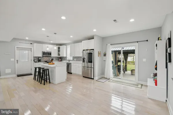 a kitchen with white cabinets and refrigerator