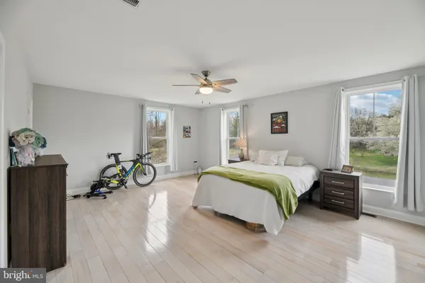 a spacious bedroom with a bed and a chandelier