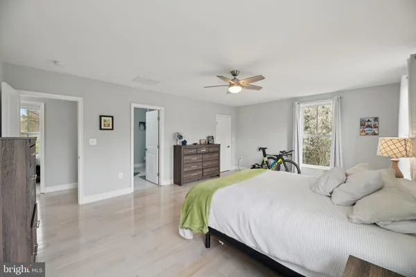 a bathroom with a granite countertop sink a mirror and shower