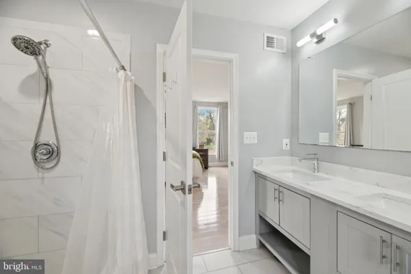 a bedroom with two beds and a window