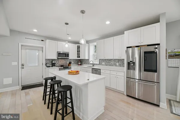 a kitchen with stainless steel appliances granite countertop a sink a stove a microwave and cabinets
