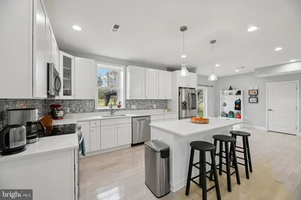a living room with furniture and kitchen view