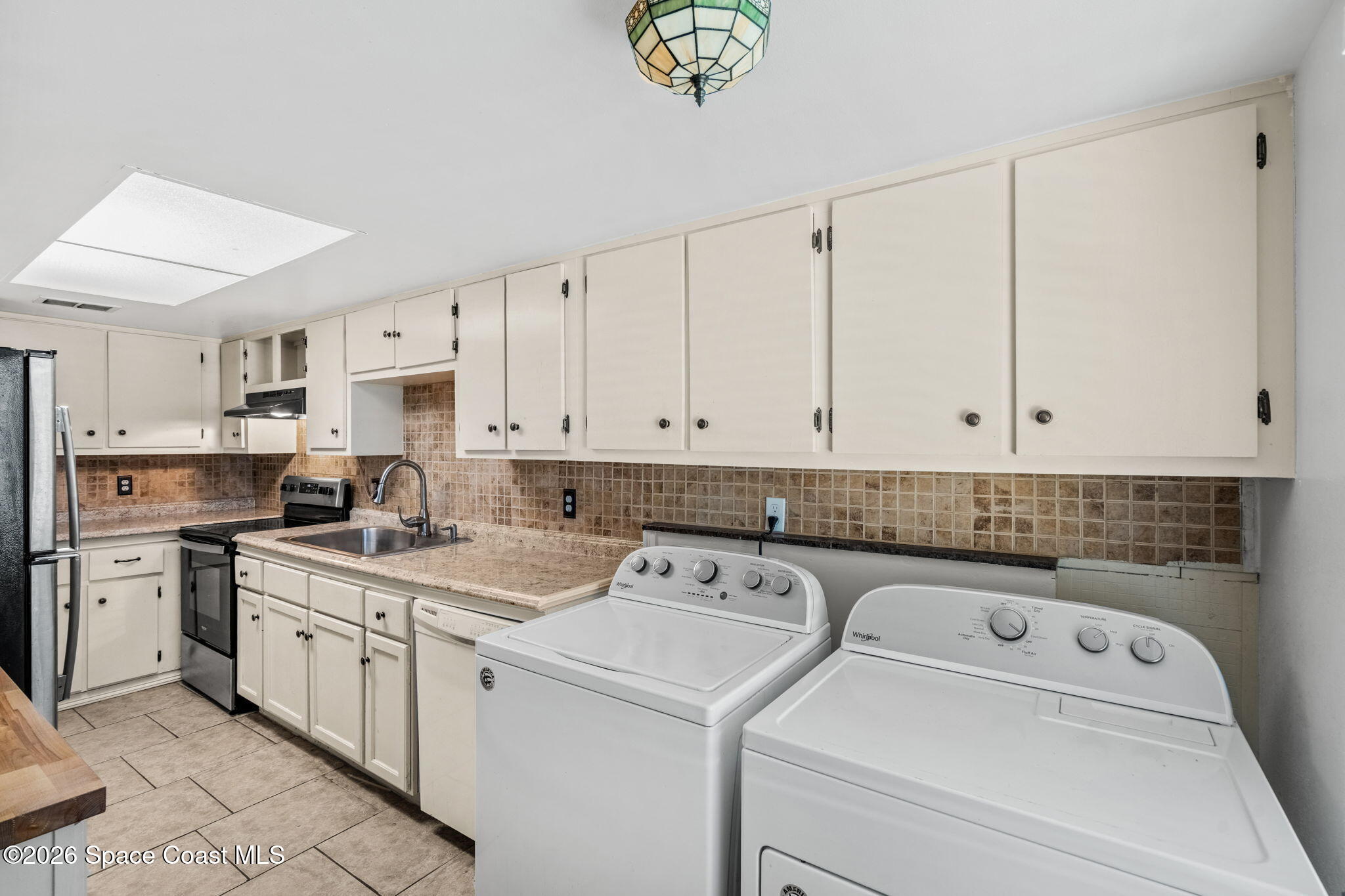 500 Catalina Road, Unit 402 Cocoa Beach, FL 32931 - Photo 11 of 34 a utility room with dryer and washer