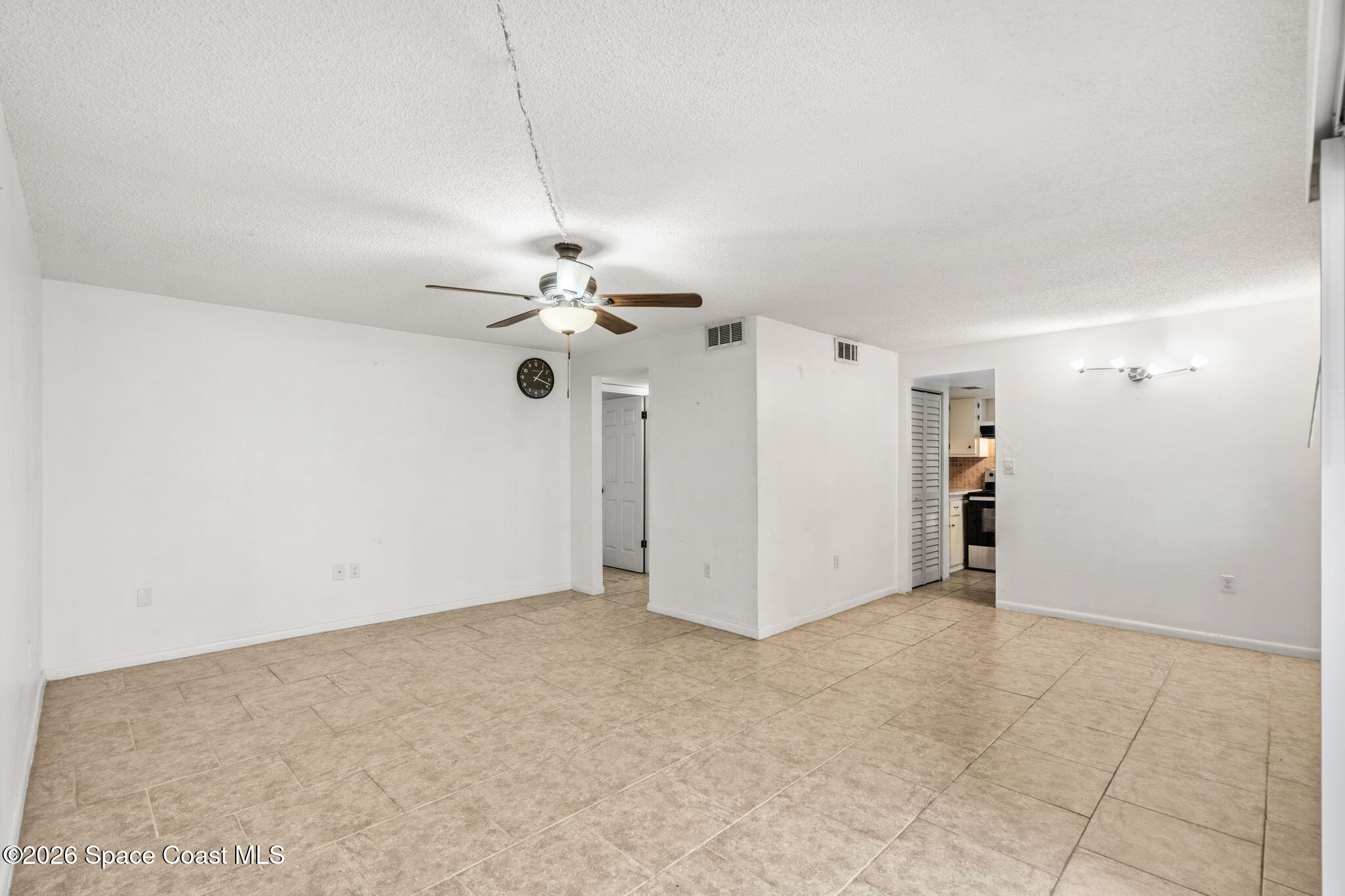 500 Catalina Road, Unit 402 Cocoa Beach, FL 32931 - Photo 12 of 34 an empty room with a ceiling fan and a window