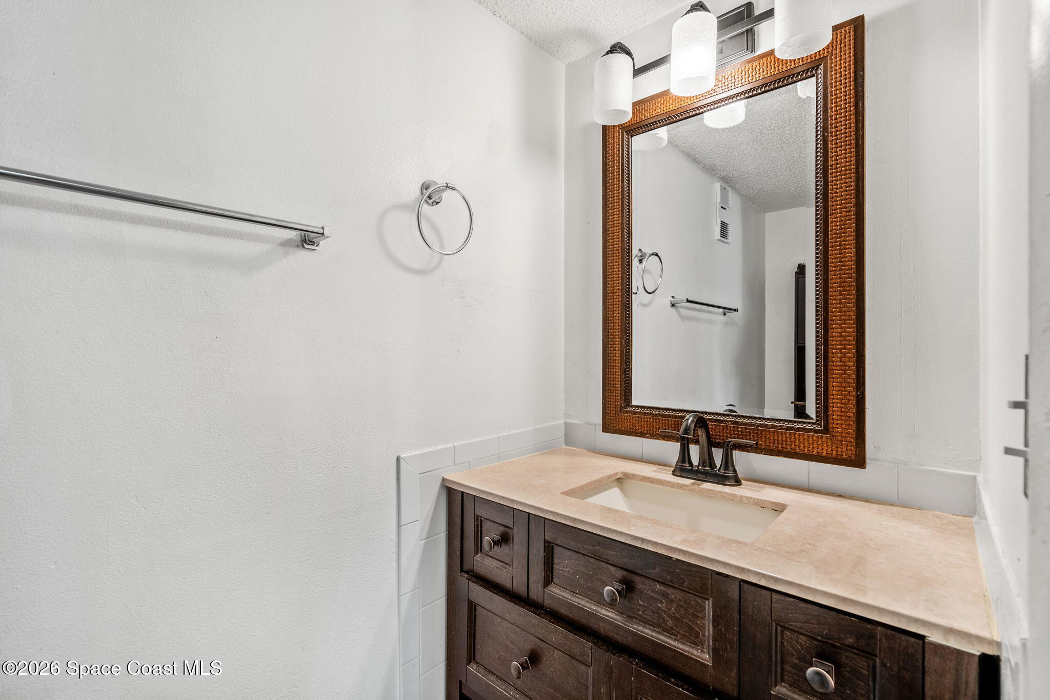500 Catalina Road, Unit 402 Cocoa Beach, FL 32931 - Photo 15 of 34 a bathroom with a sink and a mirror