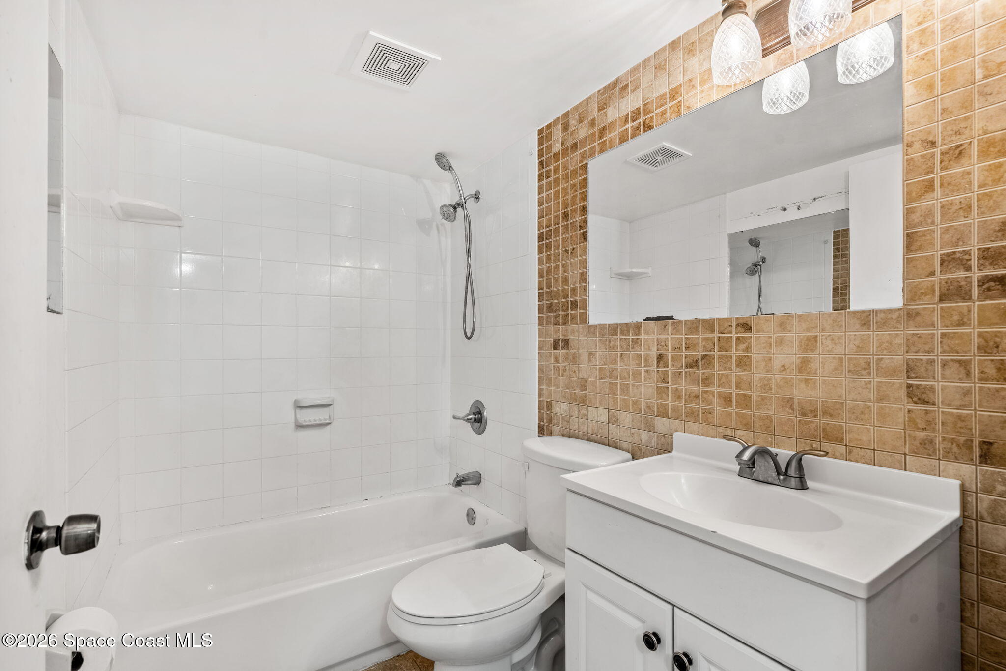 500 Catalina Road, Unit 402 Cocoa Beach, FL 32931 - Photo 18 of 34 a bathroom with a sink a toilet and shower