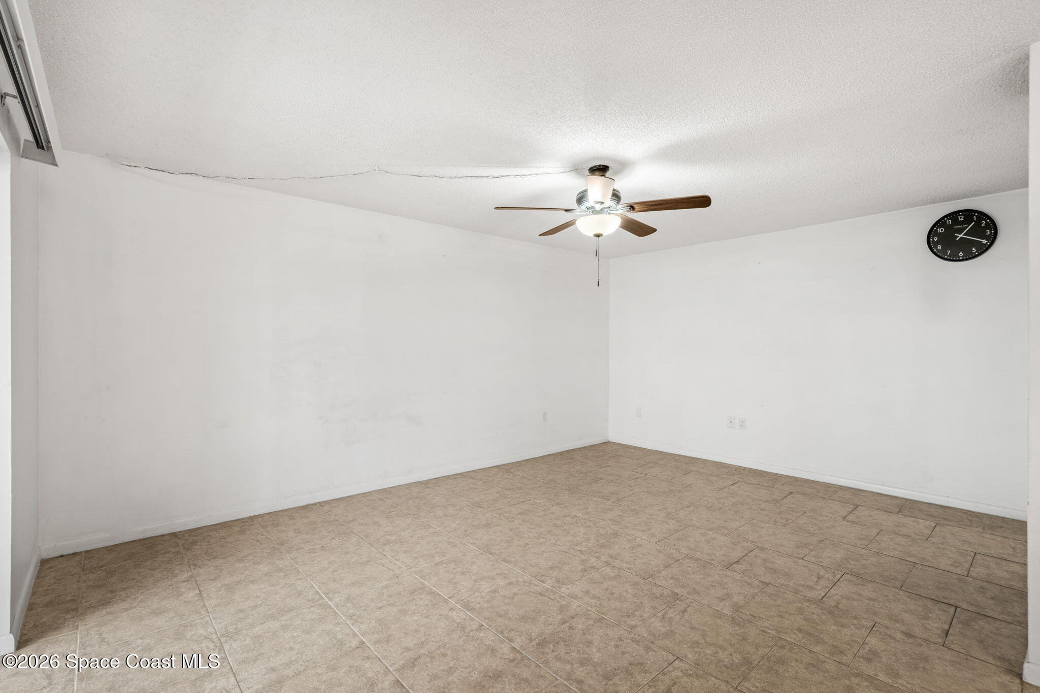 500 Catalina Road, Unit 402 Cocoa Beach, FL 32931 - Photo 19 of 34 an empty room with a fan