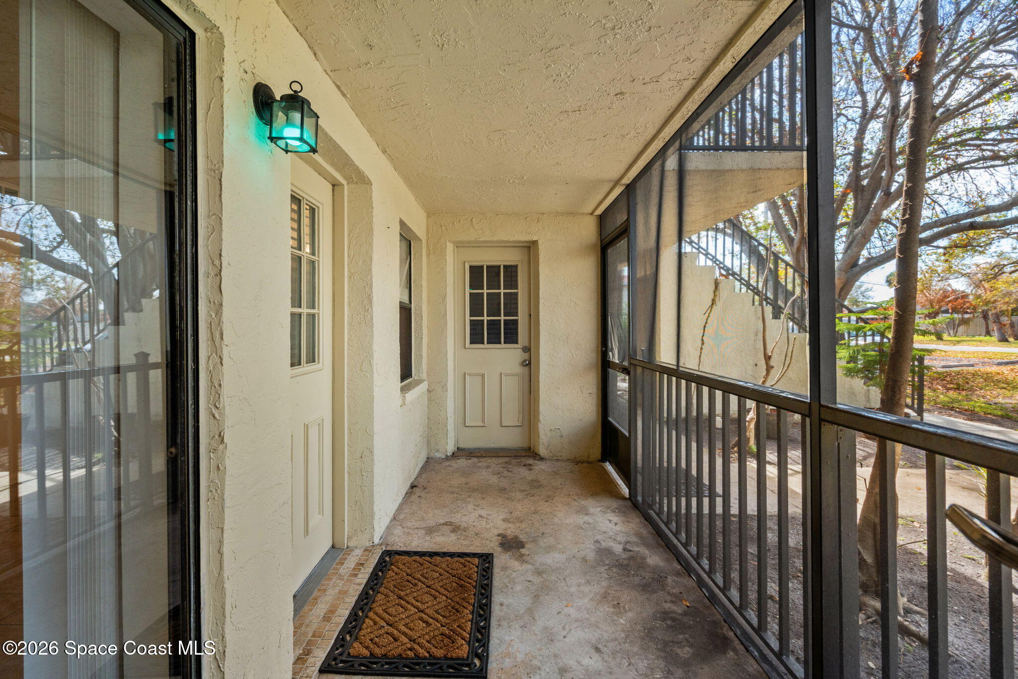 500 Catalina Road, Unit 402 Cocoa Beach, FL 32931 - Photo 21 of 34 a view of a porch with wooden floor and stairs