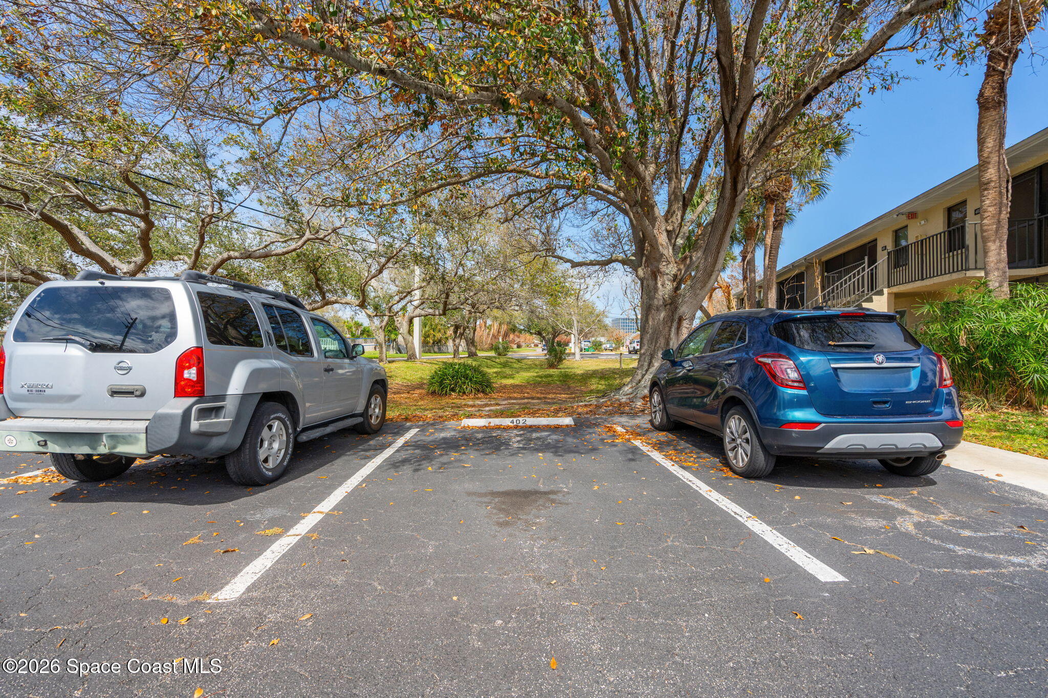 500 Catalina Road, Unit 402 Cocoa Beach, FL 32931 - Photo 24 of 34 a view of a cars parked in a parking lot
