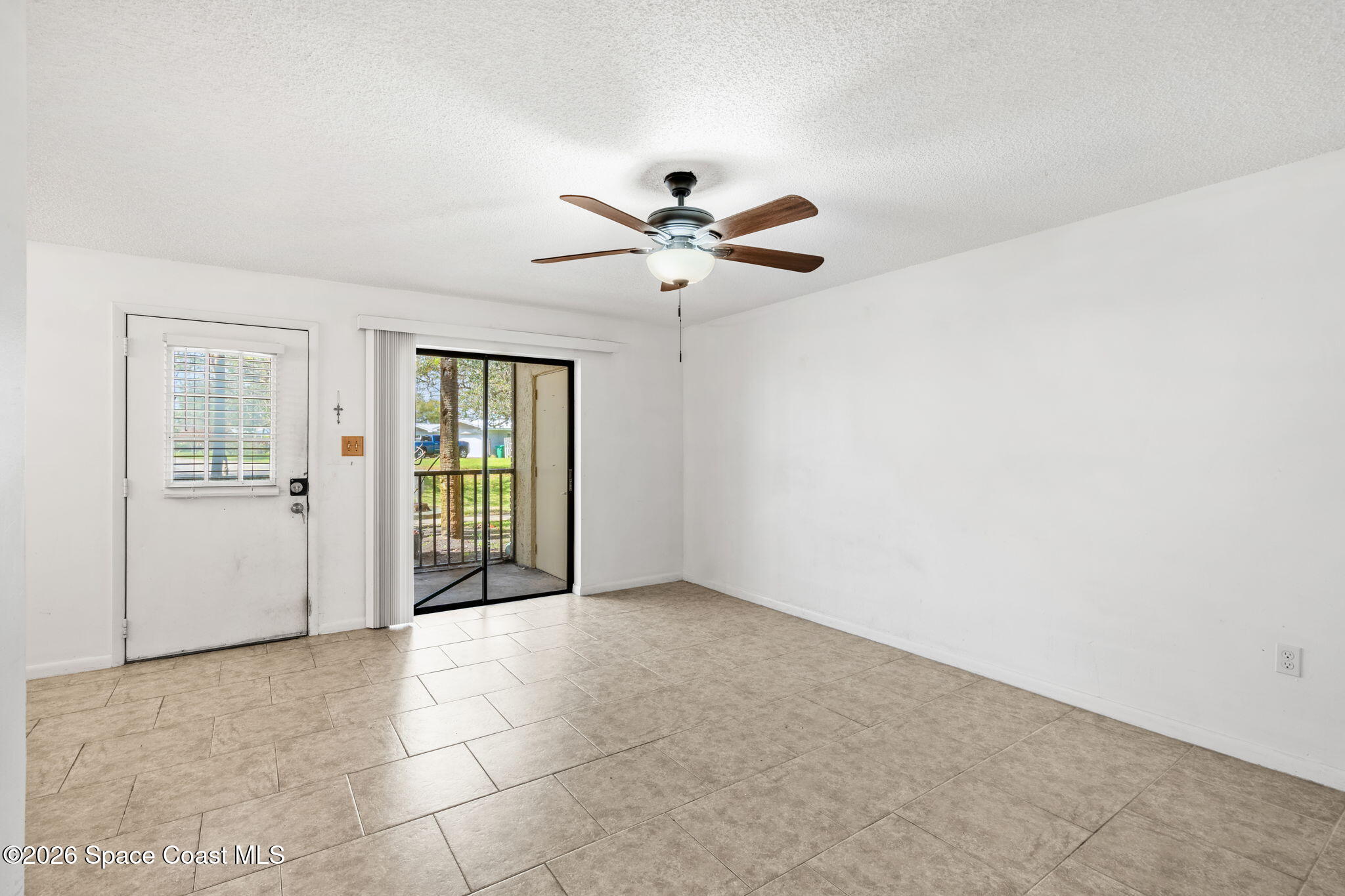 500 Catalina Road, Unit 402 Cocoa Beach, FL 32931 - Photo 3 of 34 a view of a livingroom with a ceiling fan and chandelier fan