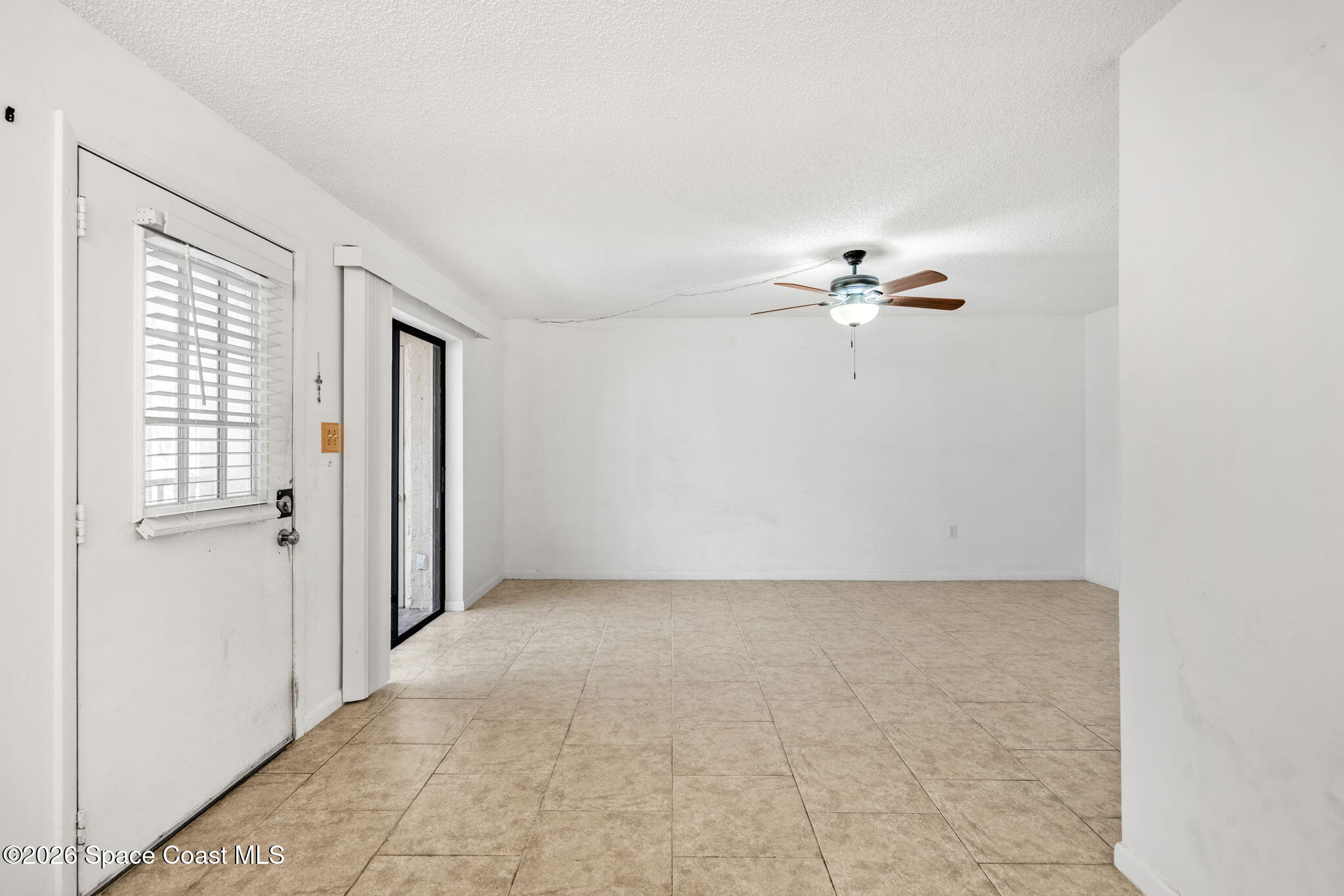 500 Catalina Road, Unit 402 Cocoa Beach, FL 32931 - Photo 4 of 34 a view of an empty room with a window