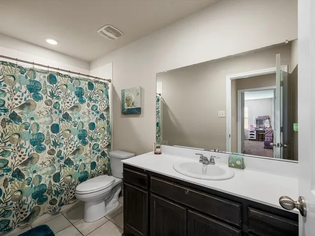 a bedroom with a bed and a view of bathroom