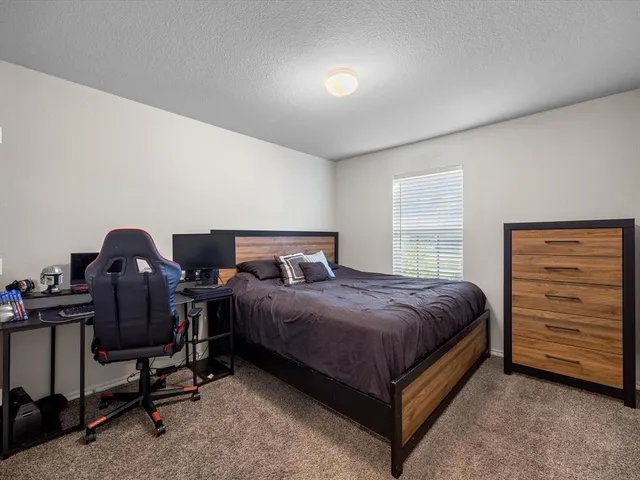a bathroom with a granite countertop sink a toilet and a mirror