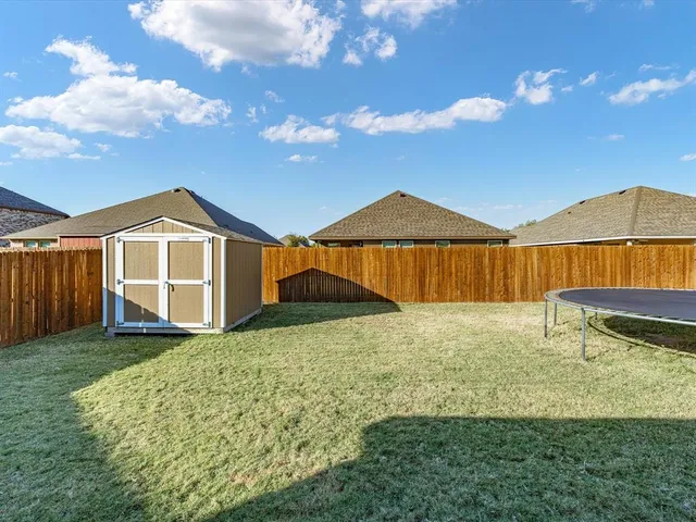 a view of a house with a yard and sitting area