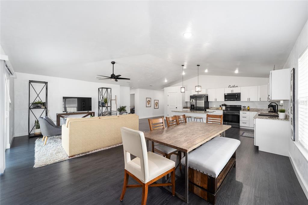 16668 Northwest 191st Way High Springs, FL 32643 - Photo 13 of 38 a view of a dining room with furniture and wooden floor