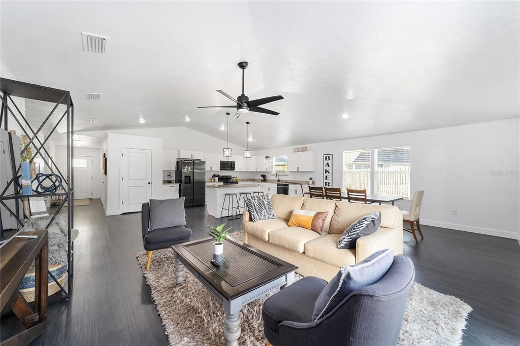 16668 Northwest 191st Way High Springs, FL 32643 - Photo 14 of 38 a living room with furniture kitchen view and a chandelier