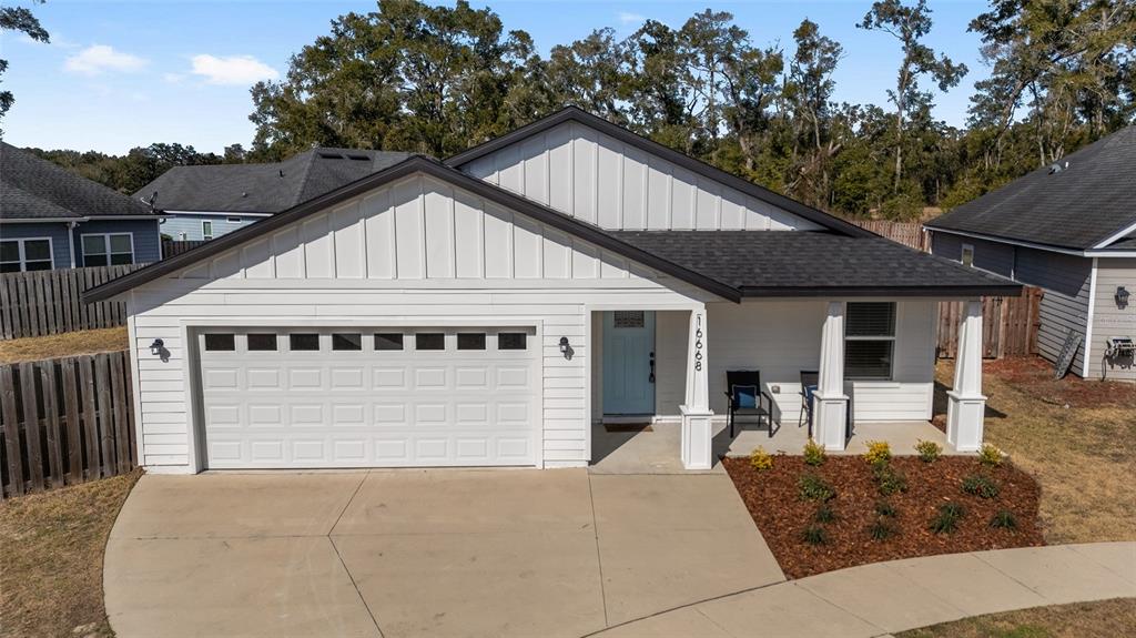 16668 Northwest 191st Way High Springs, FL 32643 - Photo 38 of 38 a front view of a house with a yard and garage