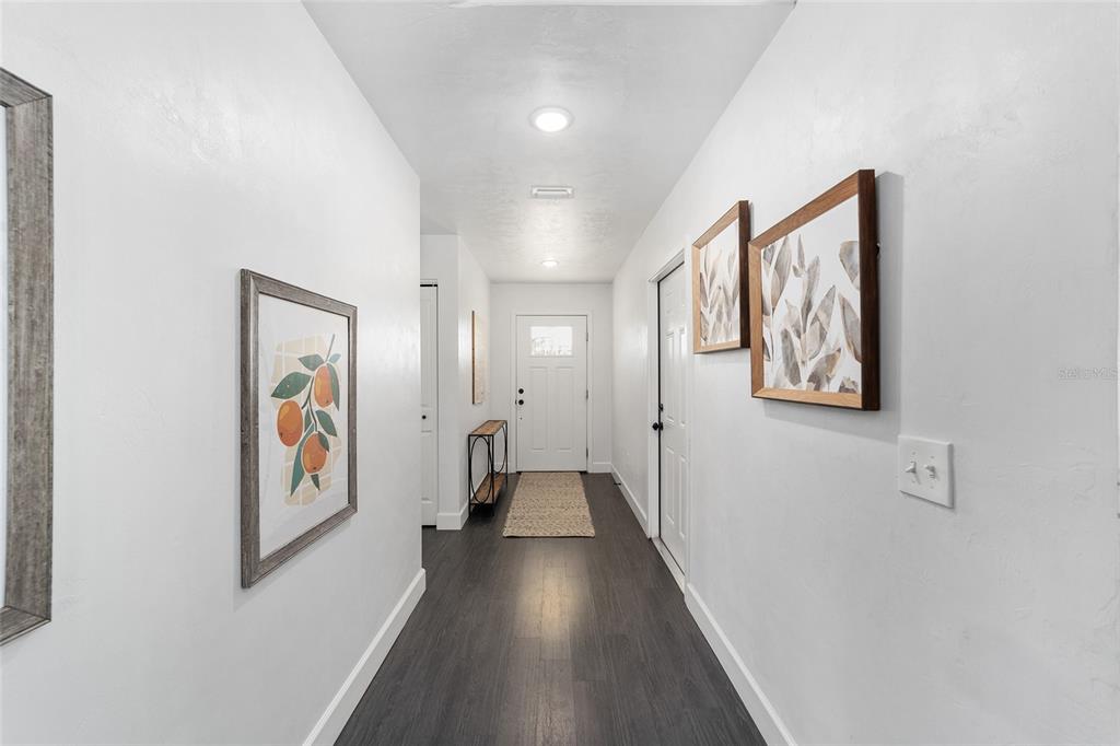 16668 Northwest 191st Way High Springs, FL 32643 - Photo 5 of 38 a hallway with wooden floor closet and wall paintings