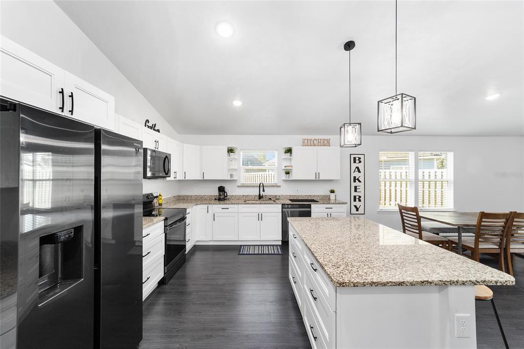 16668 Northwest 191st Way High Springs, FL 32643 - Photo 7 of 38 a kitchen with stainless steel appliances granite countertop a sink refrigerator and cabinets