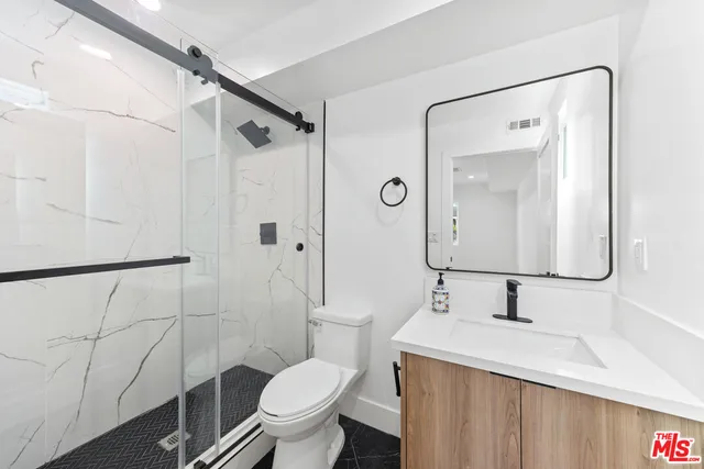 a kitchen with stainless steel appliances a refrigerator a sink a stove and a microwave