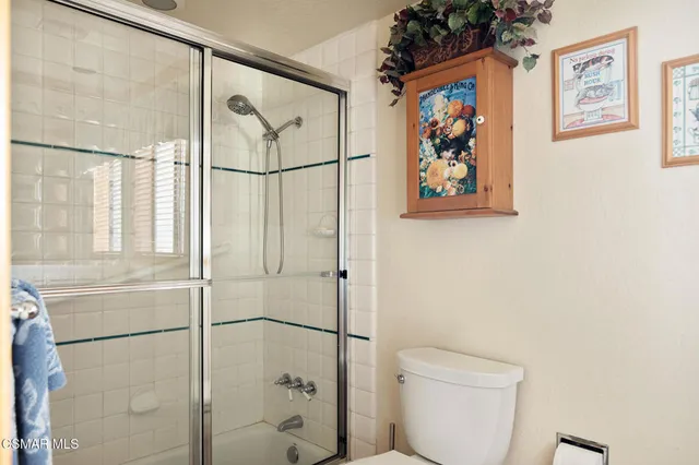 a bathroom with a shower and a toilet