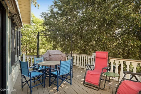 an outdoor sitting area with couch and wooden fence