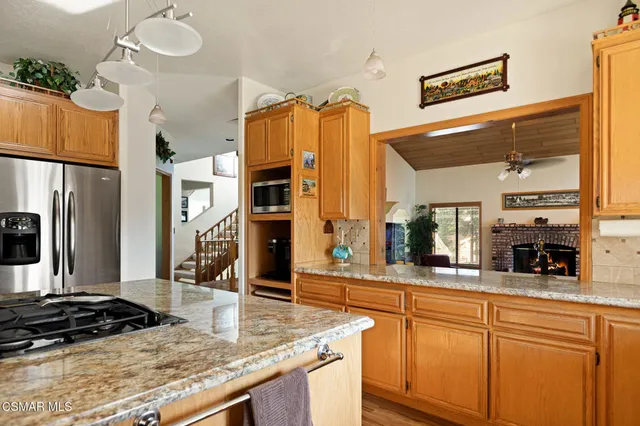 a kitchen with stainless steel appliances granite countertop a sink a counter space and cabinets