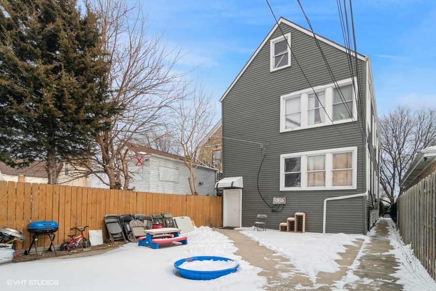 2180 North Mango Avenue Chicago, IL 60639 - Photo 15 of 18 a view of a house with a yard