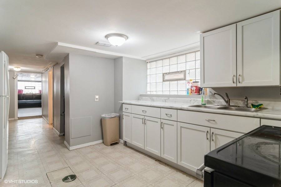 2180 North Mango Avenue Chicago, IL 60639 - Photo 3 of 18 a kitchen with a sink cabinets and window