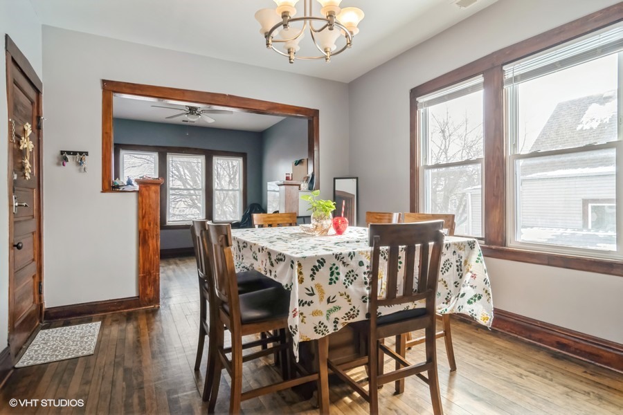 2180 North Mango Avenue Chicago, IL 60639 - Photo 4 of 18 a view of a dining room with furniture window and wooden floor