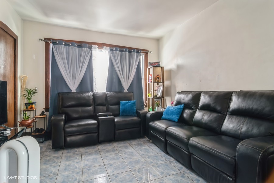 2180 North Mango Avenue Chicago, IL 60639 - Photo 10 of 18 a living room with furniture and a couch
