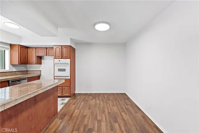 a view of a kitchen with wooden floor and a sink