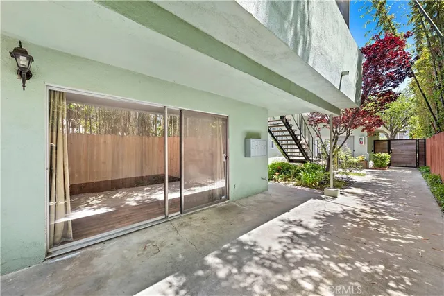 a porch with a glass door and furniture