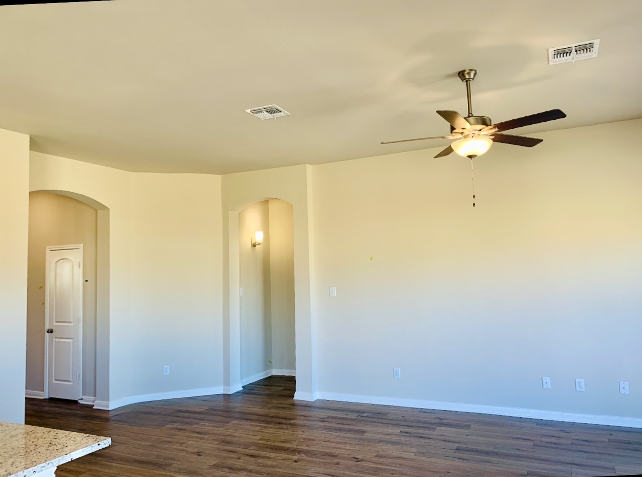 808 Fallbrook Drive Temple, TX 76502 - Photo 6 of 36 Spare room featuring arched walkways, dark wood-style floors, and a ceiling fan