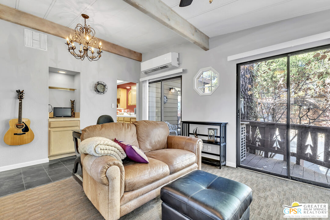 25955 Highway 243, Unit 18 Idyllwild, CA 92549 - Photo 17 of 43 a living room with furniture and a chandelier