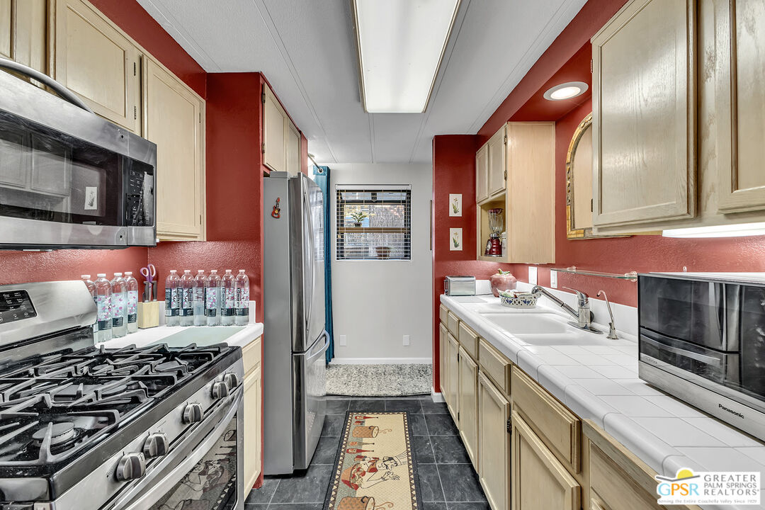 25955 Highway 243, Unit 18 Idyllwild, CA 92549 - Photo 20 of 43 a kitchen with stainless steel appliances a stove and a refrigerator