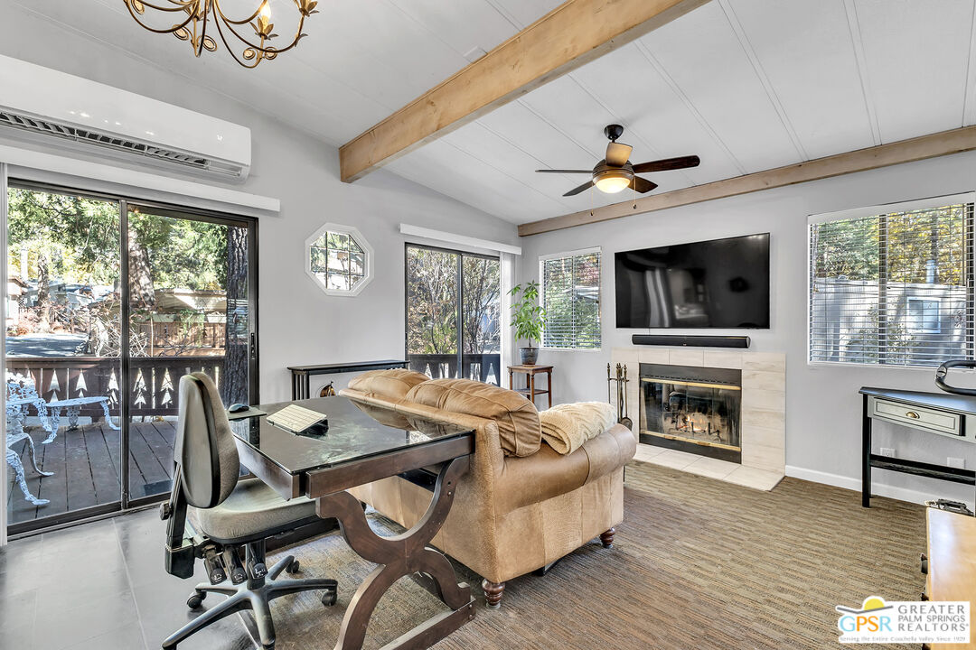 25955 Highway 243, Unit 18 Idyllwild, CA 92549 - Photo 2 of 43 a living room with furniture a flat screen tv and a fireplace