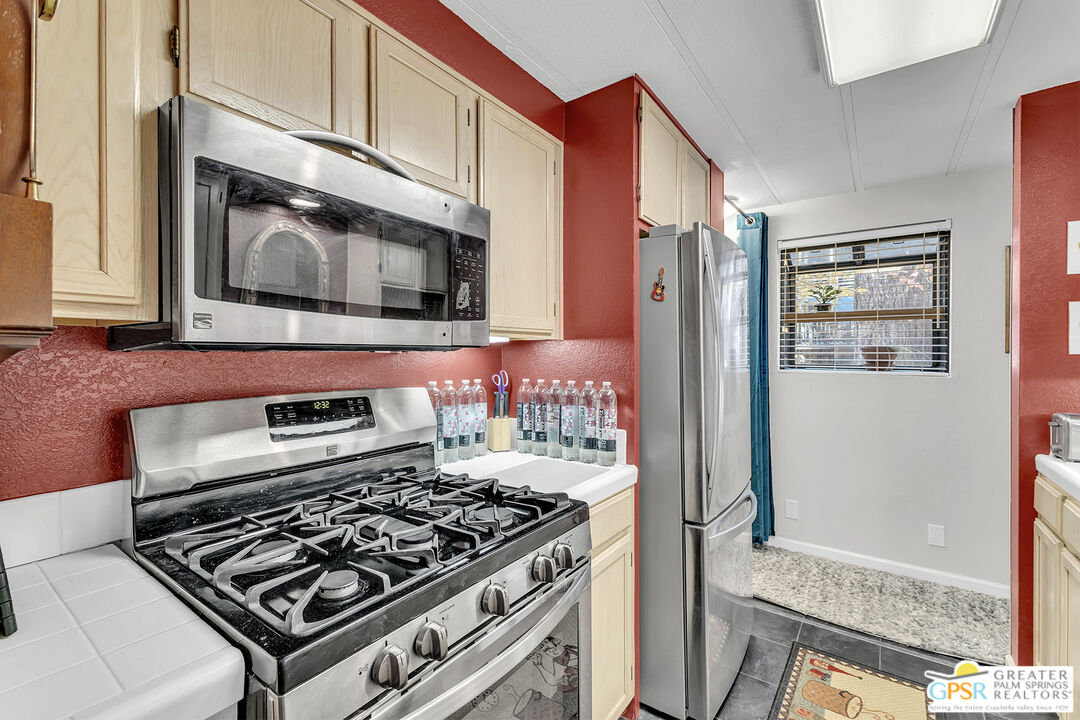 25955 Highway 243, Unit 18 Idyllwild, CA 92549 - Photo 21 of 43 a kitchen with stainless steel appliances granite countertop a stove and a microwave