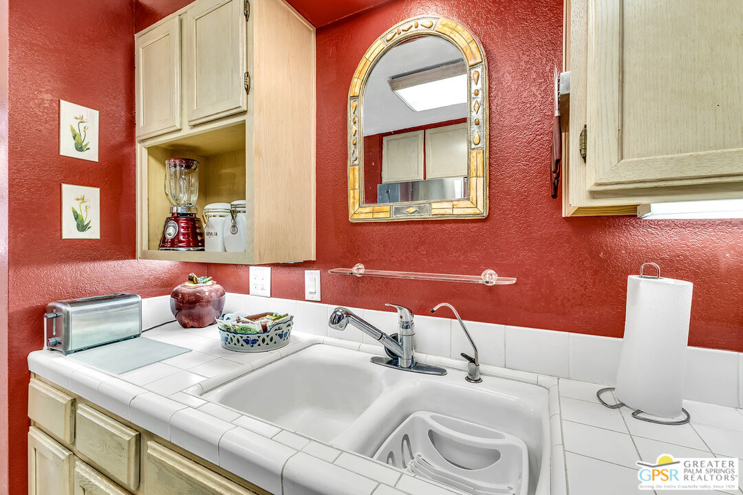 25955 Highway 243, Unit 18 Idyllwild, CA 92549 - Photo 24 of 43 a bathroom with a granite countertop sink a toilet and mirror