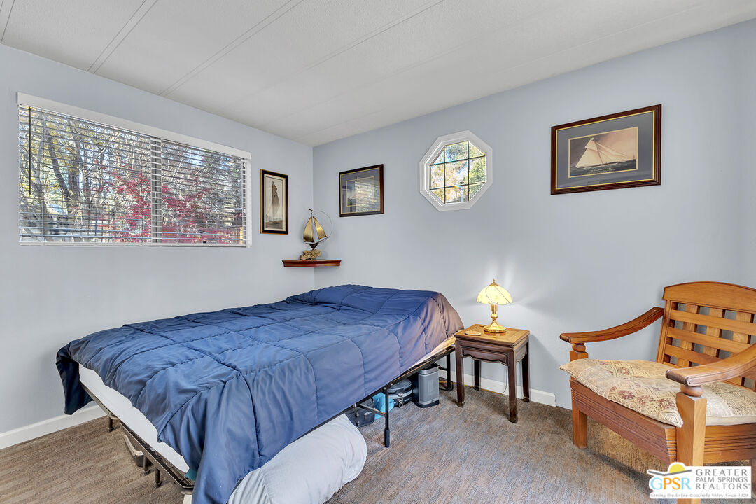 25955 Highway 243, Unit 18 Idyllwild, CA 92549 - Photo 28 of 43 a bedroom with a bed and a chandelier